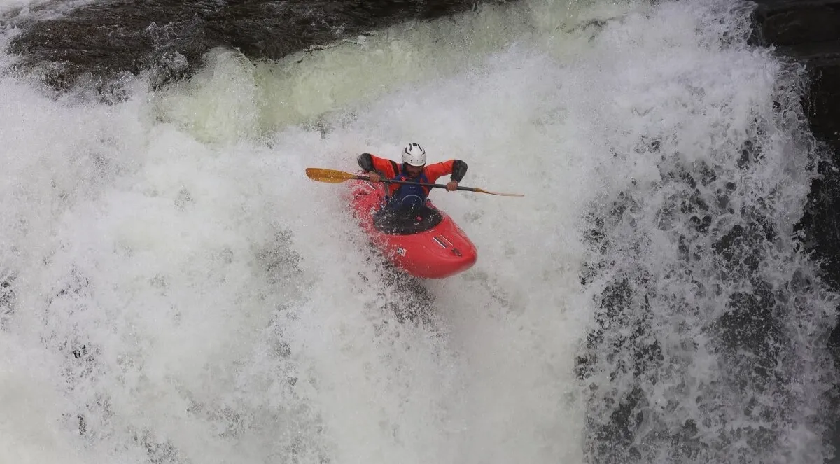 Eric kayaking over a waterfall